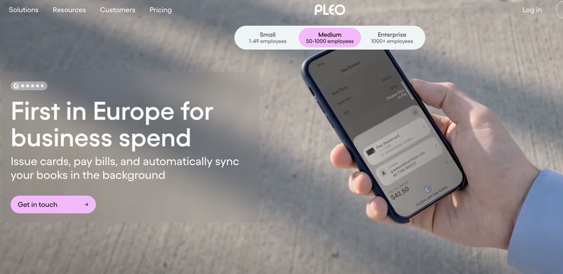 Pleo homepage with the headline First in Europe for business spend and a phone showing a card payment.